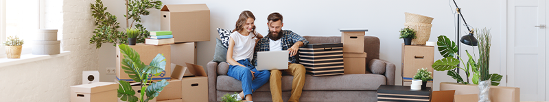 a happy young married couple moves to new apartment