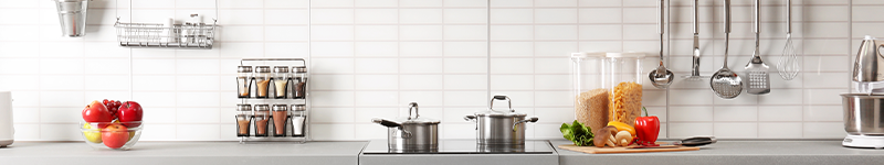 organized kitchen counter with pans,