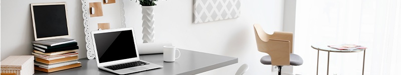 home office with computer, desk and plants