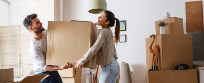 couple moving boxes together