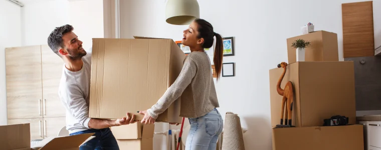 couple moving boxes together