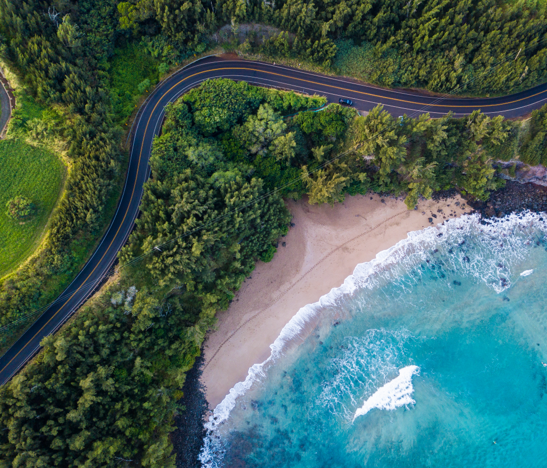 maui-01 Aerial view of the sandy beach and curved asphalt road on the west coast of Maui. Hawaii