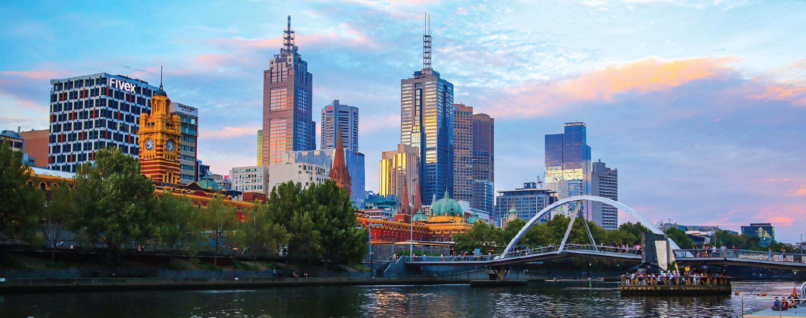 Melbourne, Australia - Mar 4, 2016 : Flinders Street Station as seen from the Sandridge Bridge over the Yarra River at sunset in Downtown Melbourne, Victoria, Australia